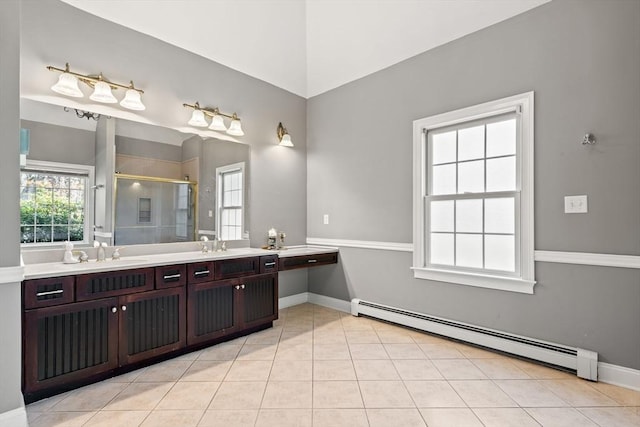 full bath featuring tile patterned flooring, vanity, baseboards, a baseboard heating unit, and a stall shower