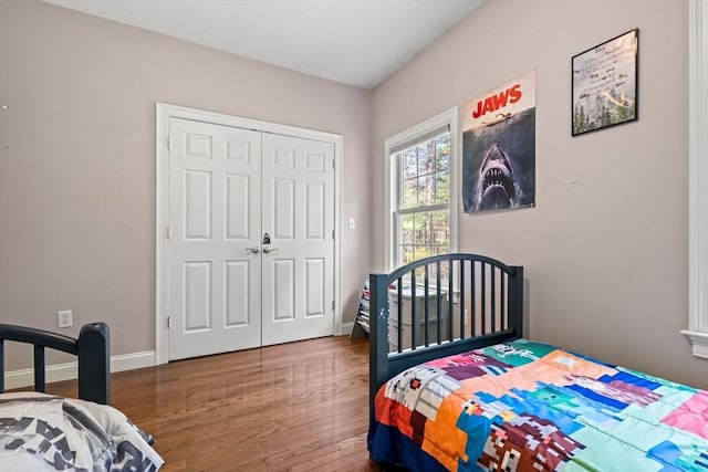 bedroom with baseboards, a closet, and wood finished floors