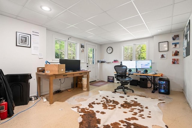 home office with baseboards and a drop ceiling