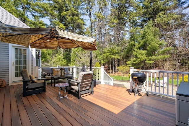 wooden deck with area for grilling and outdoor lounge area