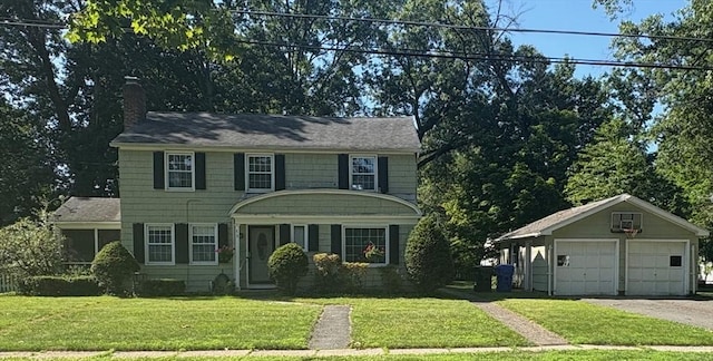 75 Bennington St, Springfield, MA 01108 - colonial inspired home with a chimney, an outdoor structure, a front yard, and a detached garage