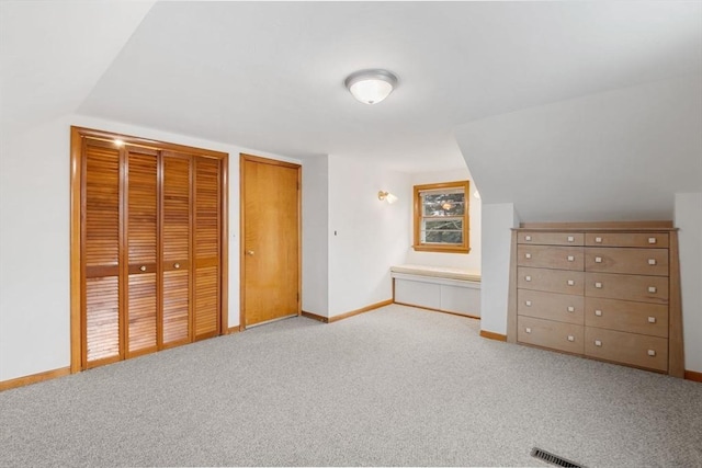 unfurnished bedroom featuring two closets, carpet flooring, and baseboards