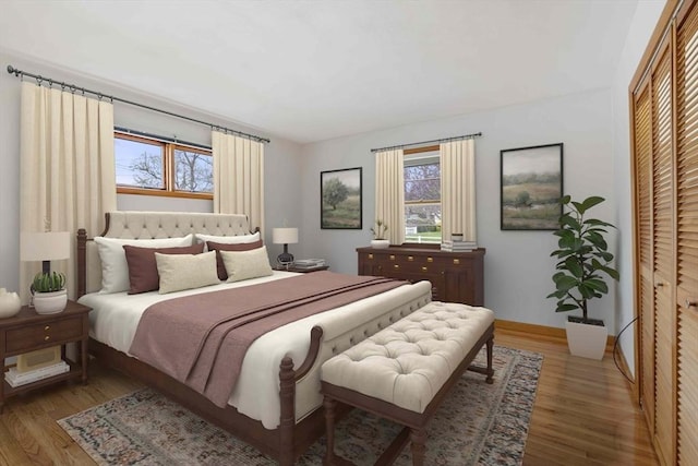 bedroom featuring wood finished floors and baseboards