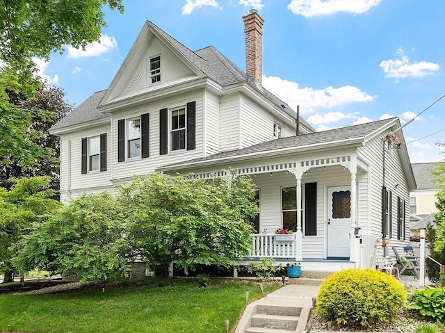 102 Chestnut St, Andover, MA 01810 - view of front facade with a porch, a chimney, a front lawn, and roof with shingles
