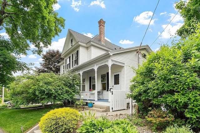 102 Chestnut St, Andover, MA 01810 - victorian-style house with covered porch, a chimney, and a front lawn