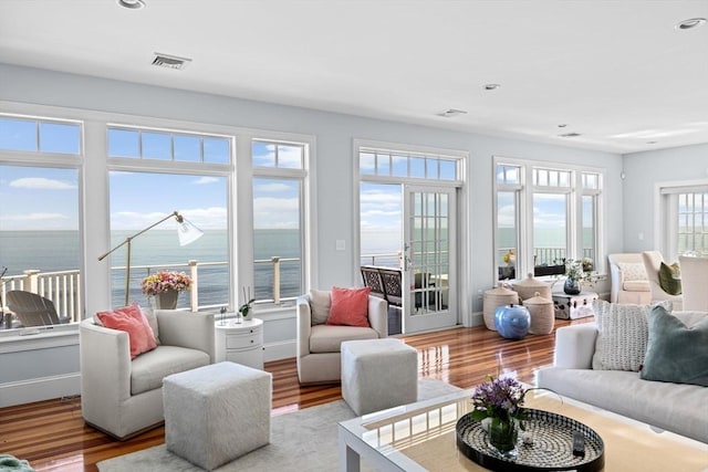 55 Seaside Rd, Scituate, MA 02066 - living area with wood finished floors, a water view, and recessed lighting