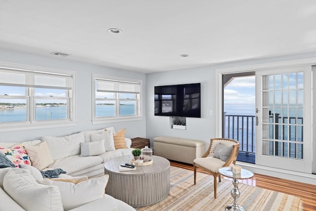 55 Seaside Rd, Scituate, MA 02066 - living room featuring light wood-style floors, a water view, and recessed lighting