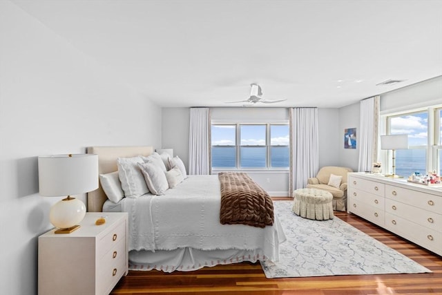 55 Seaside Rd, Scituate, MA 02066 - bedroom with wood finished floors, multiple windows, and a water view