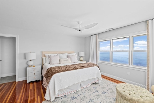 55 Seaside Rd, Scituate, MA 02066 - bedroom with baseboards, wood finished floors, a ceiling fan, and a water view