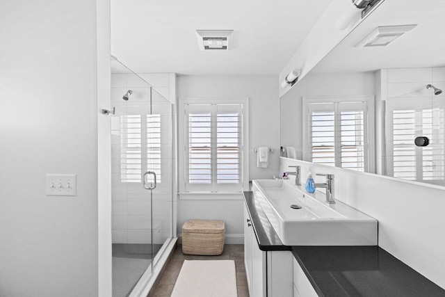 55 Seaside Rd, Scituate, MA 02066 - bathroom with a shower stall, double vanity, and baseboards