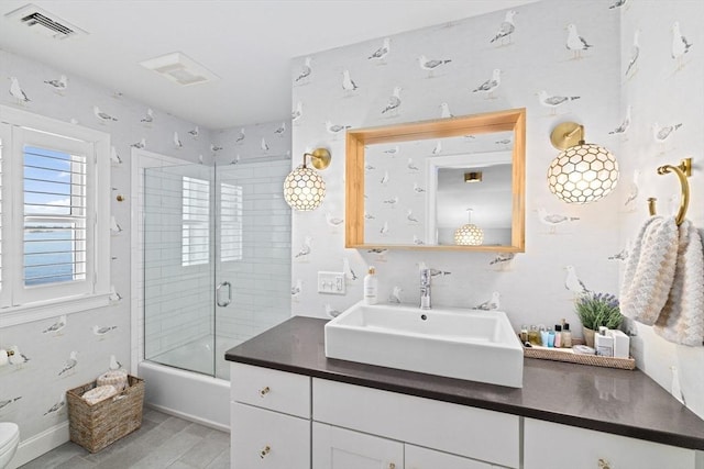 55 Seaside Rd, Scituate, MA 02066 - full bathroom featuring vanity, combined bath / shower with glass door, toilet, and wood finished floors