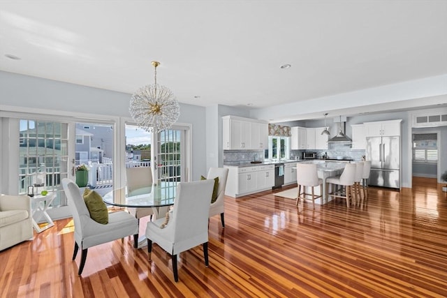 55 Seaside Rd, Scituate, MA 02066 - dining room with a chandelier, plenty of natural light, and wood finished floors
