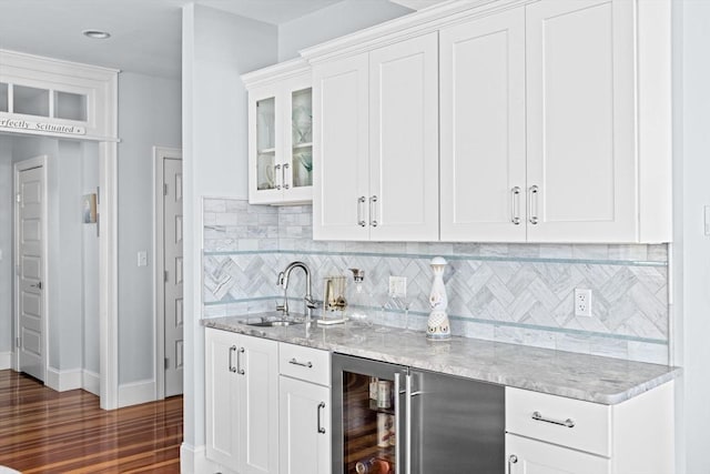 55 Seaside Rd, Scituate, MA 02066 - kitchen with wine cooler, a sink, light stone counters, white cabinetry, and recessed lighting