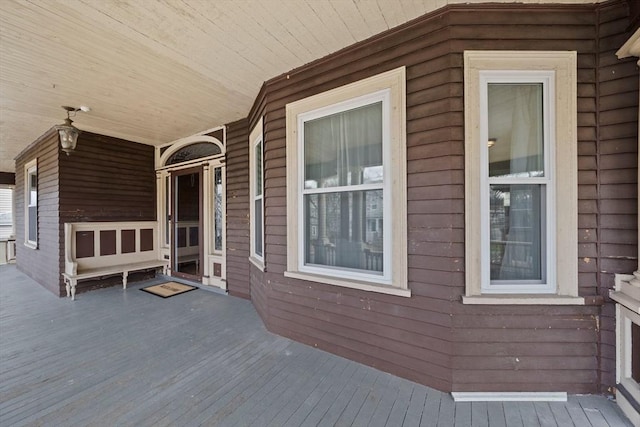 wooden terrace featuring covered porch