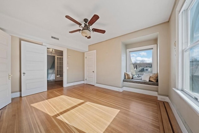 unfurnished bedroom featuring visible vents, light wood-style flooring, and baseboards