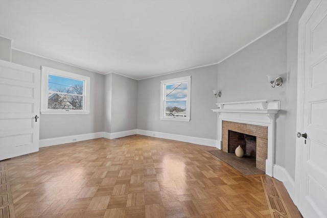 unfurnished living room with plenty of natural light, a fireplace with flush hearth, baseboards, and ornamental molding