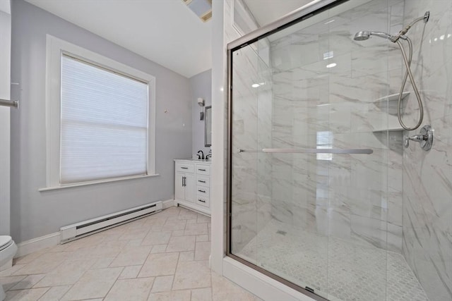 bathroom with a baseboard heating unit, toilet, vanity, and a marble finish shower