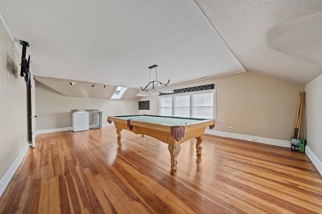 rec room with baseboards, light wood finished floors, pool table, vaulted ceiling, and a textured ceiling