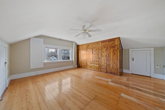 bonus room with baseboards, lofted ceiling, light wood-style floors, and ceiling fan