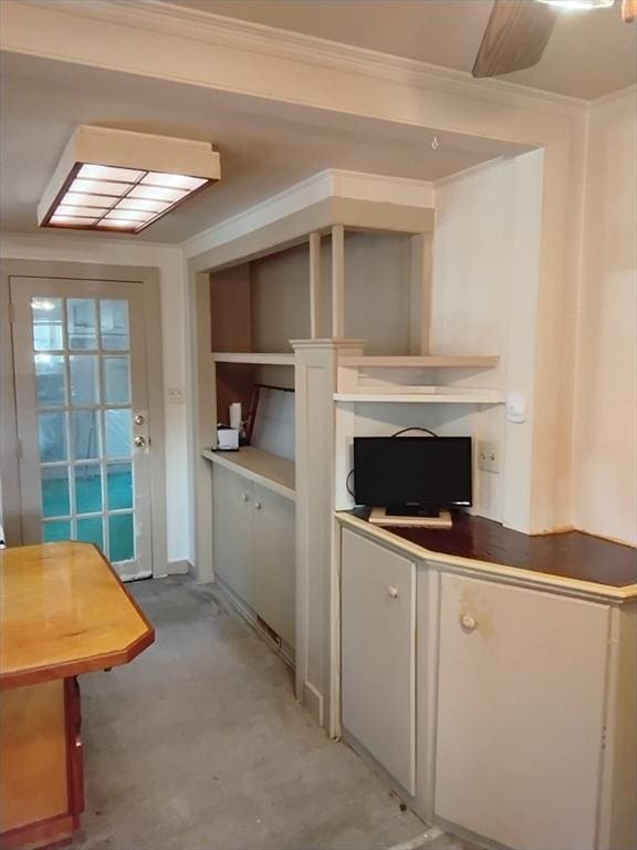 kitchen with ornamental molding and white cabinets