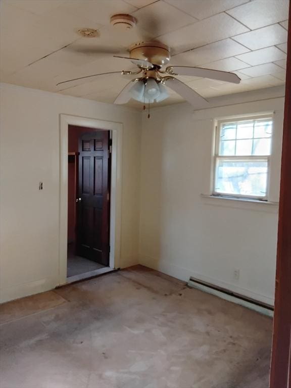 empty room with baseboards, baseboard heating, and a ceiling fan