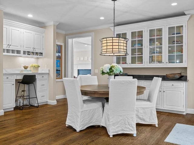 50 Temple Rd, Wellesley, MA 02482 - dining room with ornamental molding, dark wood-type flooring, recessed lighting, baseboards, and built in desk