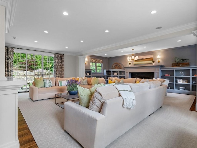 50 Temple Rd, Wellesley, MA 02482 - living room featuring crown molding, decorative columns, recessed lighting, wood finished floors, and a chandelier