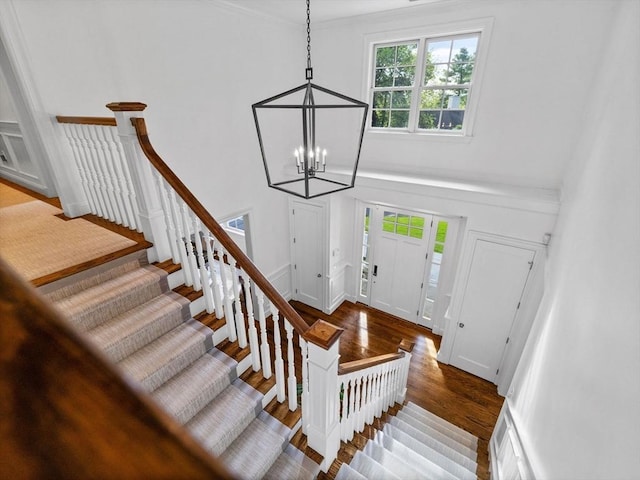 50 Temple Rd, Wellesley, MA 02482 - entrance foyer with wood finished floors, a chandelier, stairs, and ornamental molding