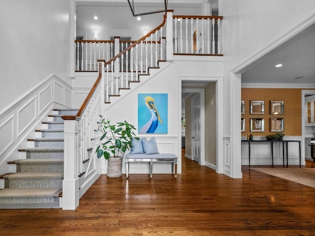 50 Temple Rd, Wellesley, MA 02482 - stairway featuring a decorative wall, ornamental molding, wood finished floors, recessed lighting, and a wainscoted wall
