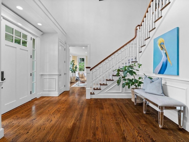 50 Temple Rd, Wellesley, MA 02482 - foyer entrance featuring a decorative wall, wood finished floors, stairway, recessed lighting, and wainscoting