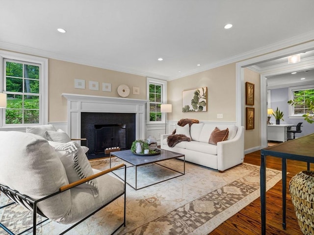 50 Temple Rd, Wellesley, MA 02482 - living area featuring light wood finished floors, ornamental molding, recessed lighting, a fireplace with flush hearth, and wainscoting
