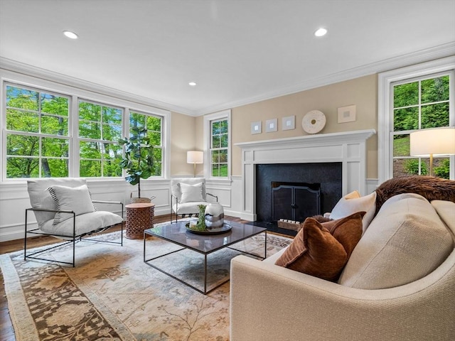 50 Temple Rd, Wellesley, MA 02482 - living area featuring wood finished floors, crown molding, plenty of natural light, recessed lighting, and a fireplace with flush hearth