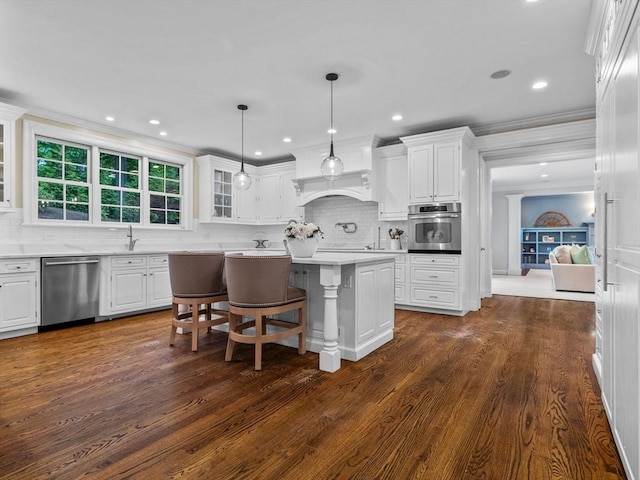 50 Temple Rd, Wellesley, MA 02482 - kitchen with stainless steel appliances, white cabinets, a kitchen island, tasteful backsplash, and dark wood finished floors