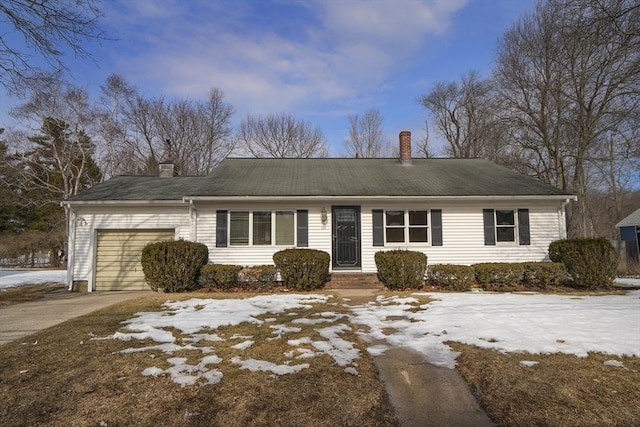 single story home with a garage, a chimney, and concrete driveway