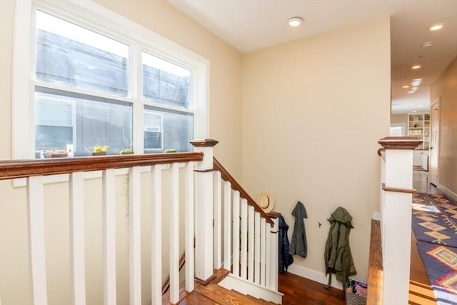 stairway with recessed lighting, baseboards, and wood finished floors