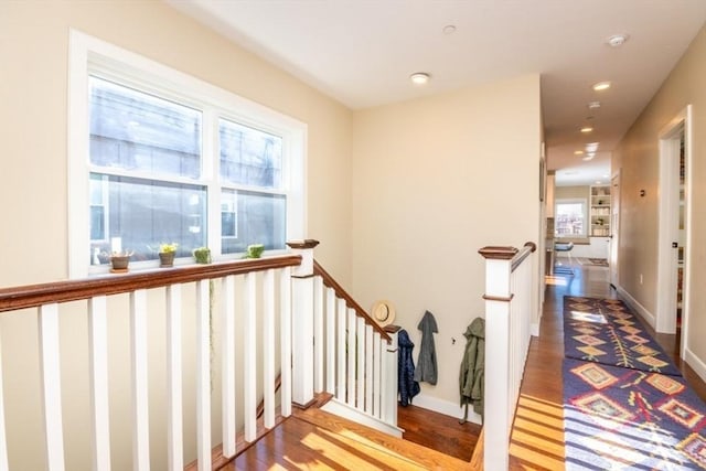 hall featuring an upstairs landing, recessed lighting, baseboards, and wood finished floors