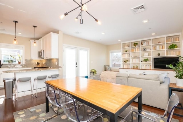 dining area with dark wood-style floors, visible vents, a healthy amount of sunlight, and recessed lighting