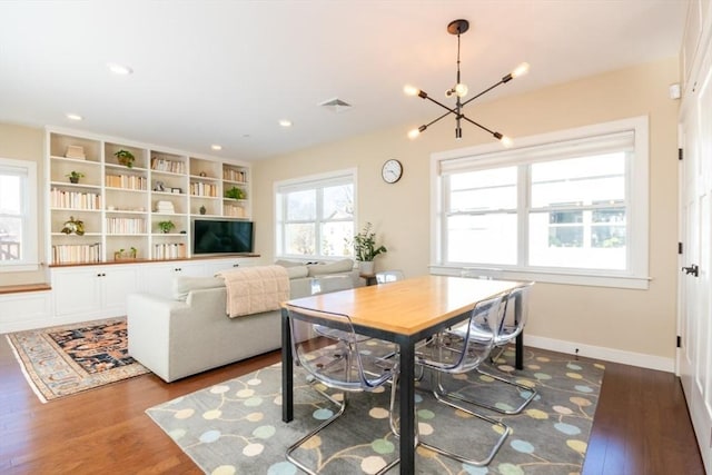 dining space with visible vents, a notable chandelier, dark wood-style floors, recessed lighting, and baseboards