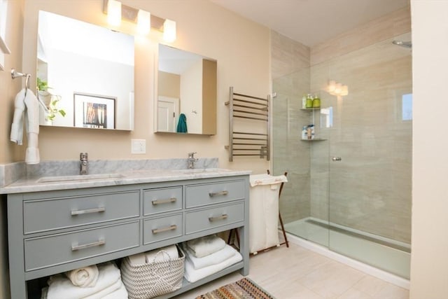 bathroom with radiator, a tile shower, and a sink