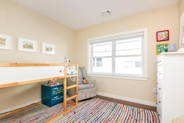 bedroom with visible vents and baseboards