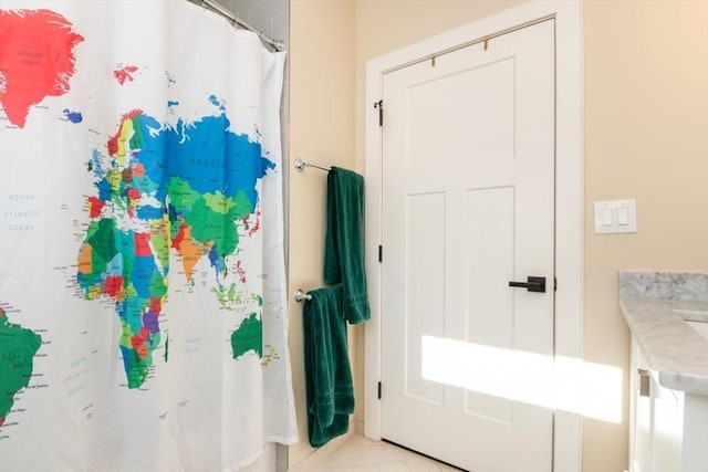 bathroom featuring a shower with shower curtain and tile patterned floors