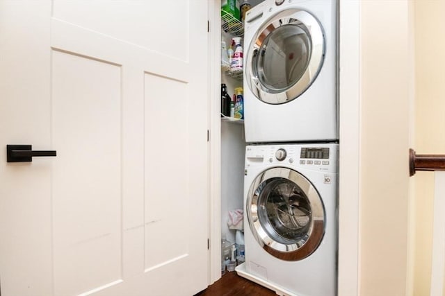 laundry room featuring stacked washer / drying machine and laundry area