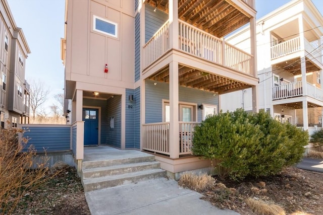 doorway to property with board and batten siding and covered porch