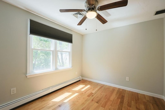 unfurnished room with baseboard heating, light wood-style floors, baseboards, and a ceiling fan