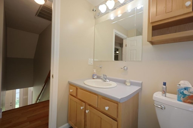 bathroom featuring toilet and vanity