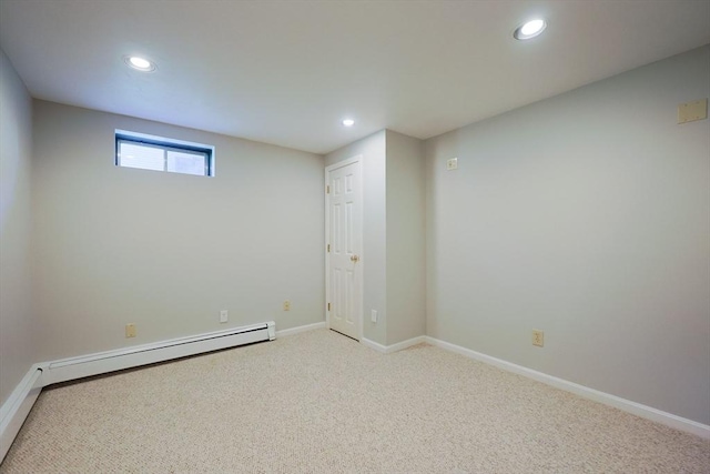 below grade area featuring a baseboard heating unit, recessed lighting, baseboards, and carpet floors
