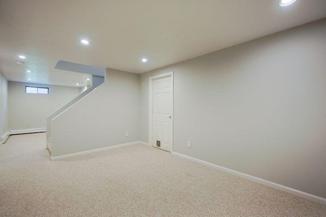 basement featuring recessed lighting, light carpet, and baseboards