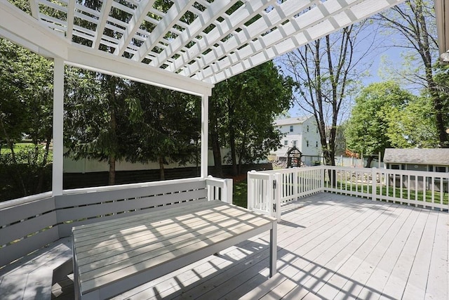 deck featuring a pergola and an outdoor structure