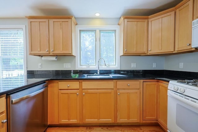 kitchen featuring stainless steel dishwasher, white range with gas cooktop, a sink, light brown cabinetry, and recessed lighting
