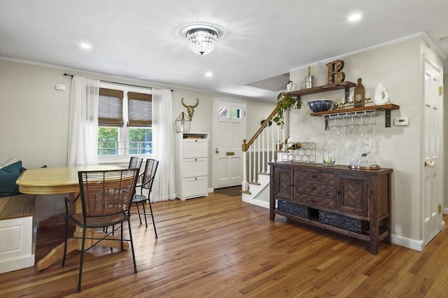 101 Eastern Ave, Woburn, MA 01801 - dining space with crown molding, stairs, wood finished floors, a dry bar, and recessed lighting